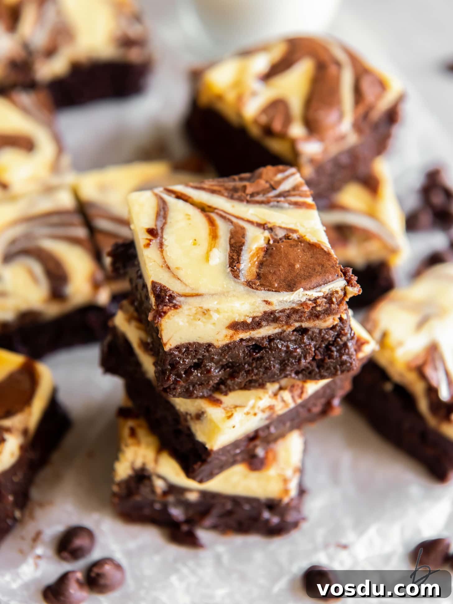 stack of cream cheese brownies with swirl on tops.