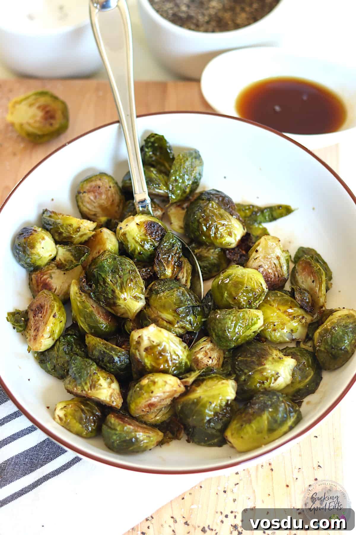 Maple-Balsamic Glazed Brussels Sprouts — Air Fryer or Oven 2 A round white bowl of roasted brussels sprouts glazed with maple syrup and balsamic vinegar.