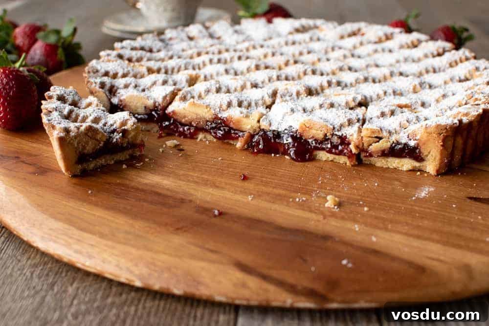 Perfectly Rustic Strawberry Crostata Recipe for Summer Baking 2 Strawberry crostata recipe cut with jam oozing.