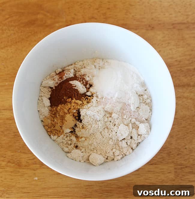 Moist Carrot Muffins with Cinnamon and Maple Glaze 5 Flour, baking powder, and sea salt in a white bowl.