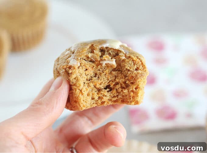 Moist Carrot Muffins with Cinnamon and Maple Glaze 9 Hand holding a muffin.