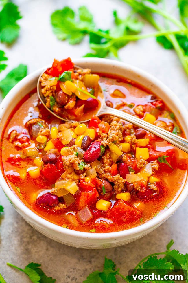 Easy 30-Minute Beef Taco Chili in a bowl with a spoon on top.