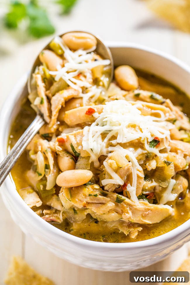 A bowl of 30-Minute Homemade White Chicken Chili with a spoon on top.