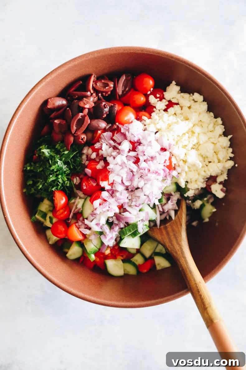 Mediterranean Chickpea Salad with Lemon-Herb Vinaigrette 3 ingredients for mediterranean chickpea salad in a large brown bowl.
