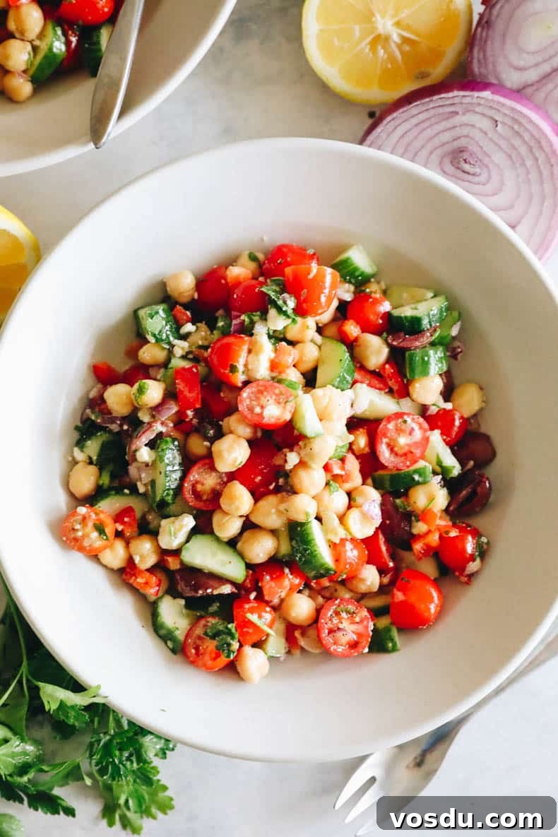 Mediterranean Chickpea Salad with Lemon-Herb Vinaigrette 7 overhead image of mediterranean salad in a white bowl.