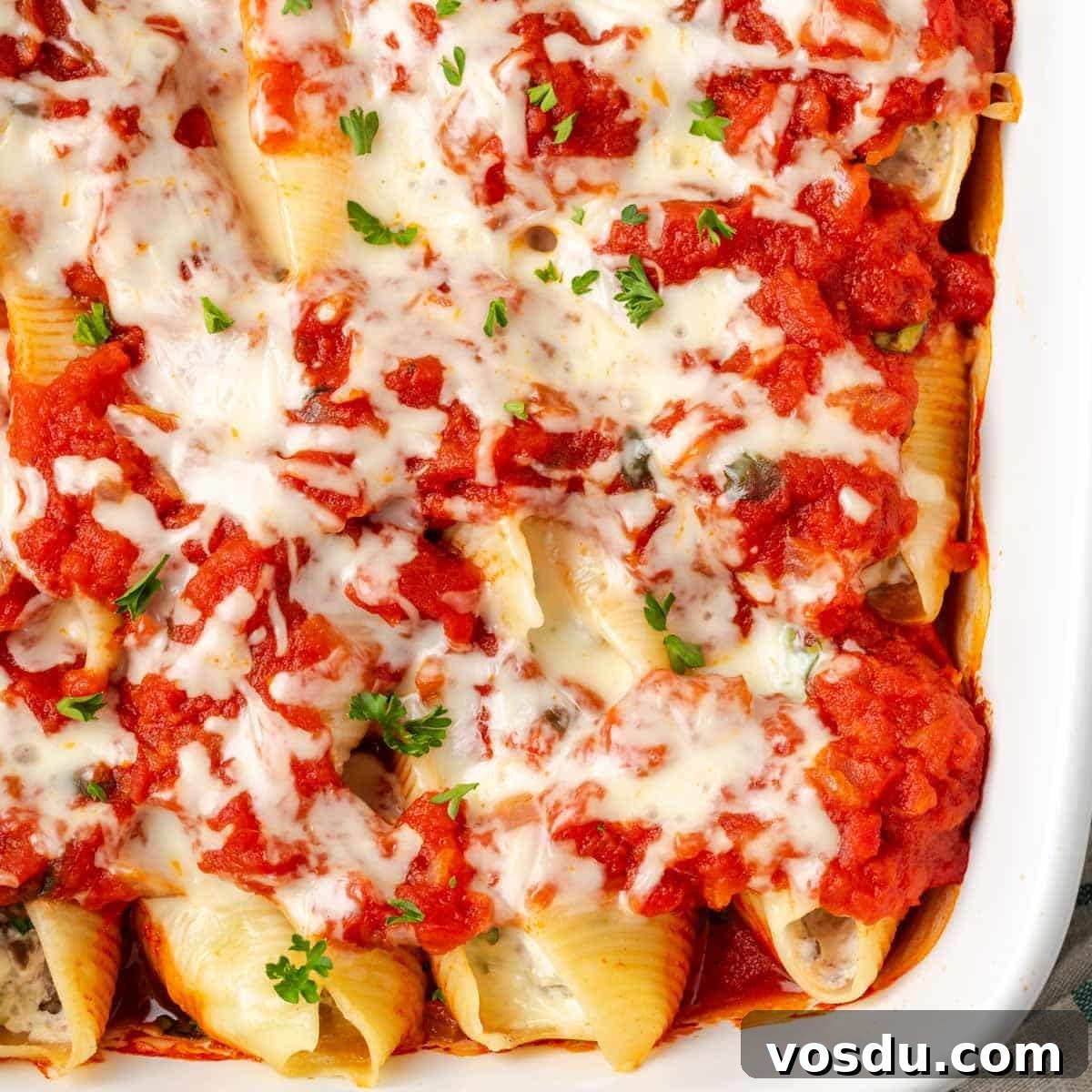 Cheesy Baked Stuffed Shells with Italian Meat Filling 6 baked stuffed shells in dish.