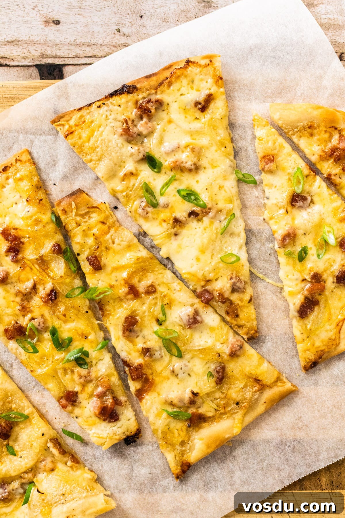 A top down view of a sliced German pizza.