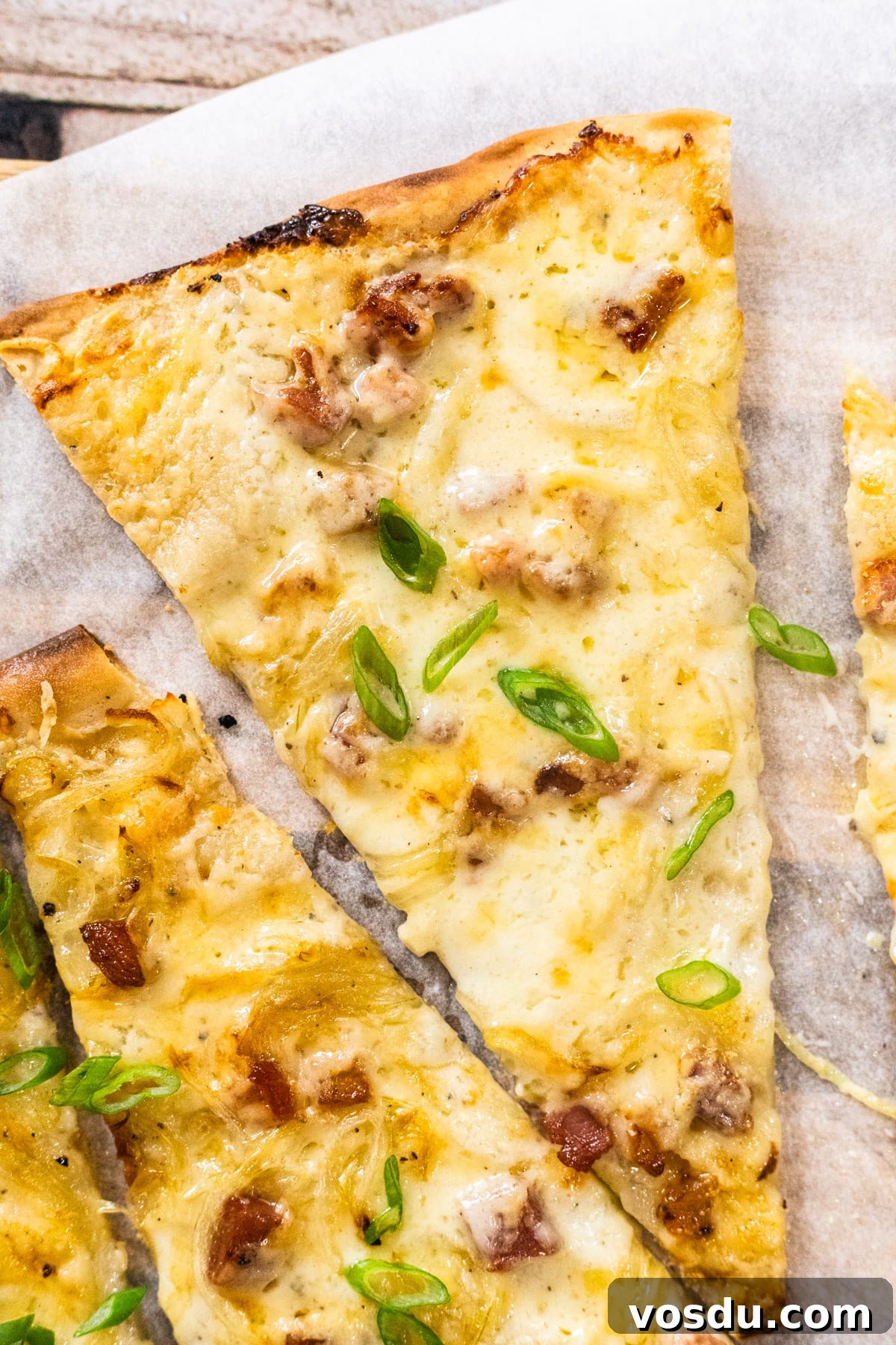 A close up view of a slice of German pizza.