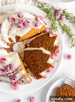 Classic Bûche de Noël Recipe: Traditional French Yule Log Cake 8 gingerbread bundt cake with cream cheese frosting with two slices cut and leaning against cake