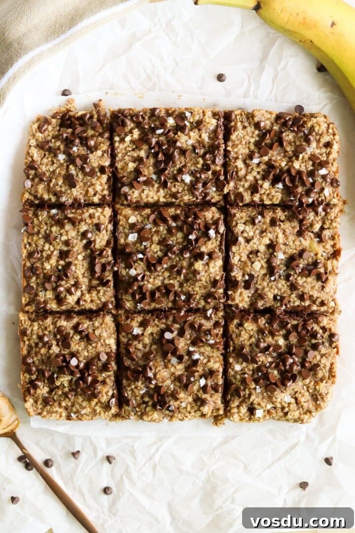 9 banana peanut butter oats bars sliced into squares and displayed on parchment paper