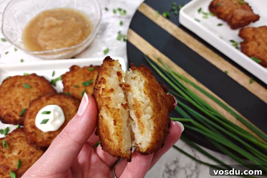 Air Fryer Trader Joe’s Frozen Latkes (Crispy Potato Pancakes) 3 holding a potato latke open showing the warm inside