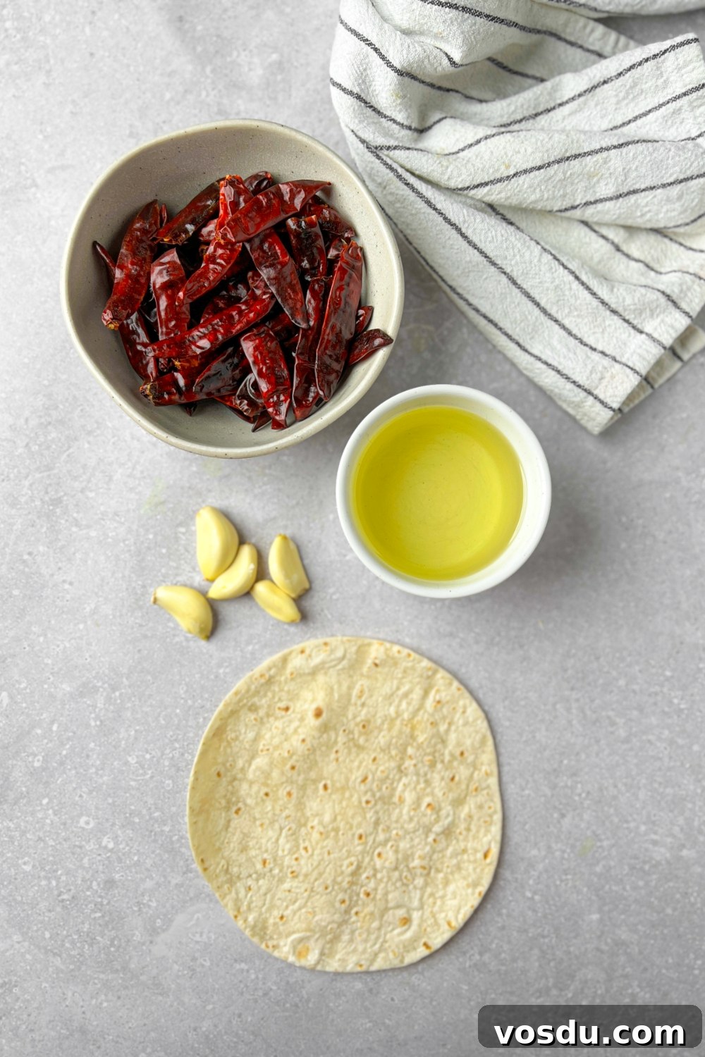 A variety of ingredients laid out on a table to make salsa macha.