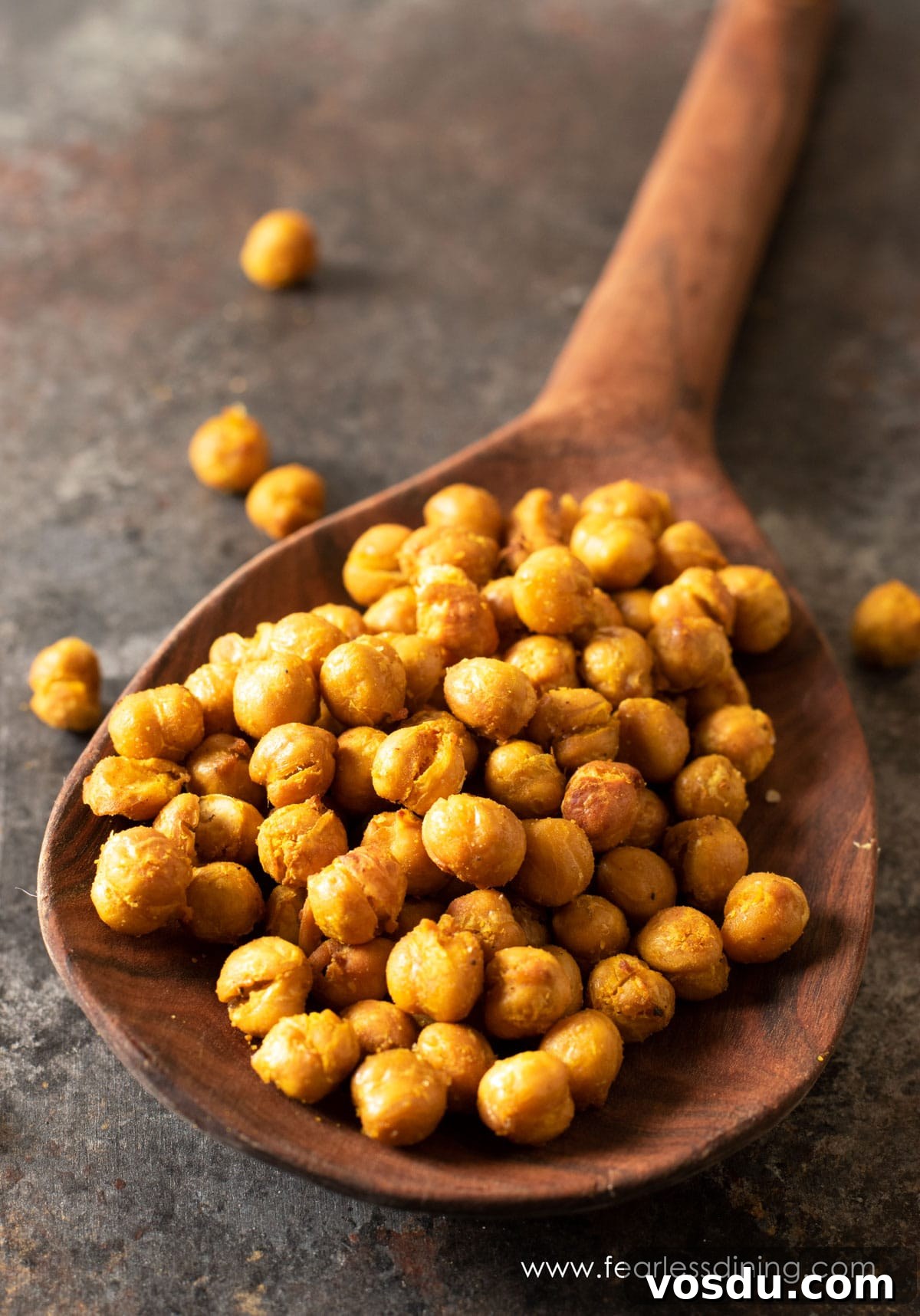 Crispy Air-Fried Chickpeas: 6 Flavor-Packed Snack Recipes 2 A wooden spoon full of air fried garbanzo beans.