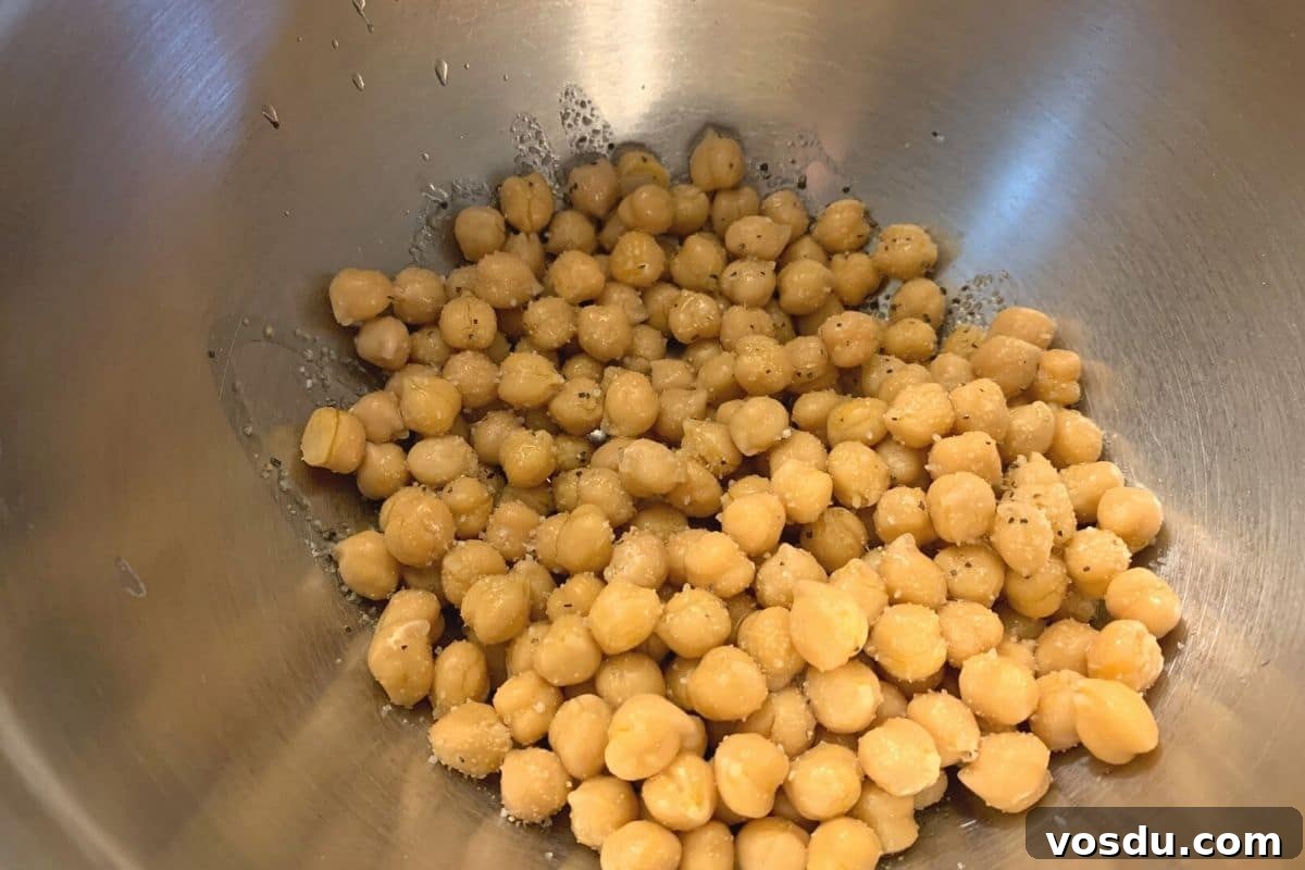 Crispy Air-Fried Chickpeas: 6 Flavor-Packed Snack Recipes 3 The chickpeas in a large silver bowl.
