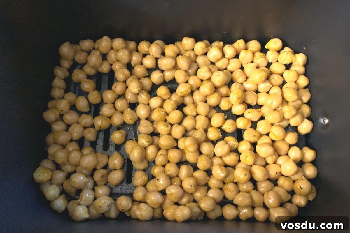 Crispy Air-Fried Chickpeas: 6 Flavor-Packed Snack Recipes 4 The garbanzo beans in an air fryer basket ready to roast.