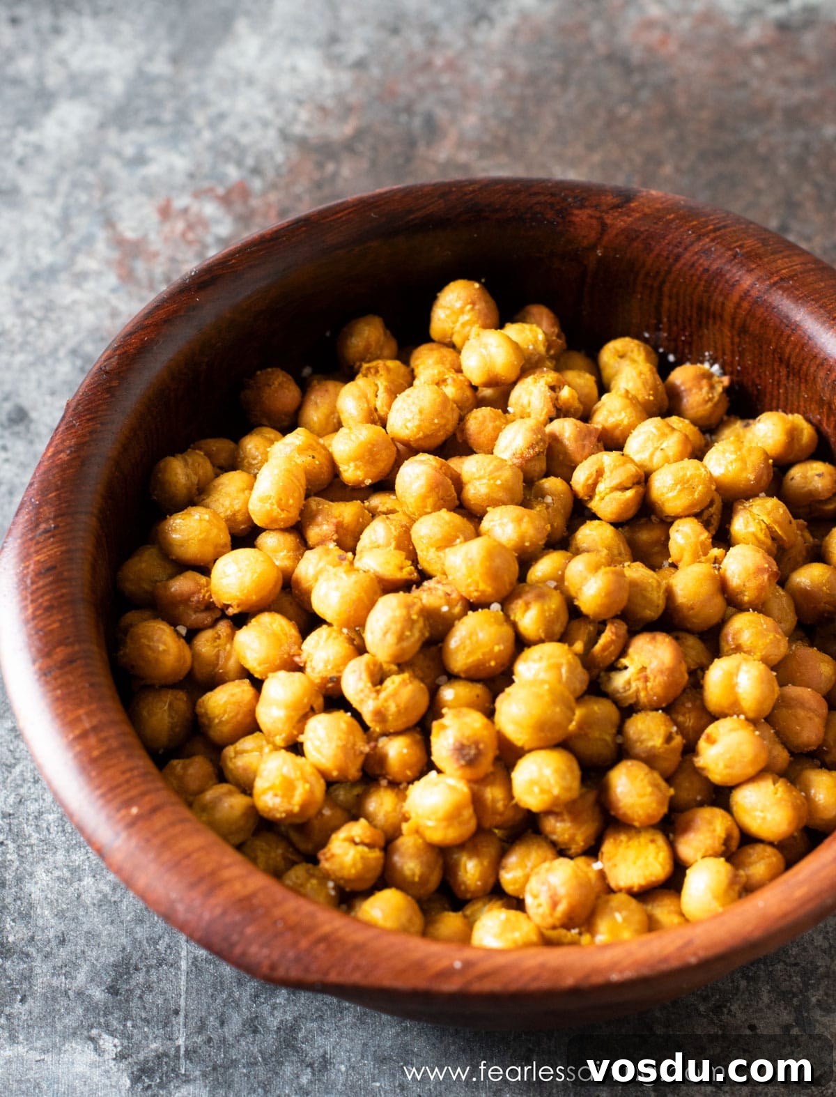 Crispy Air-Fried Chickpeas: 6 Flavor-Packed Snack Recipes 5 A wooden bowl full of crunchy garbanzo beans.
