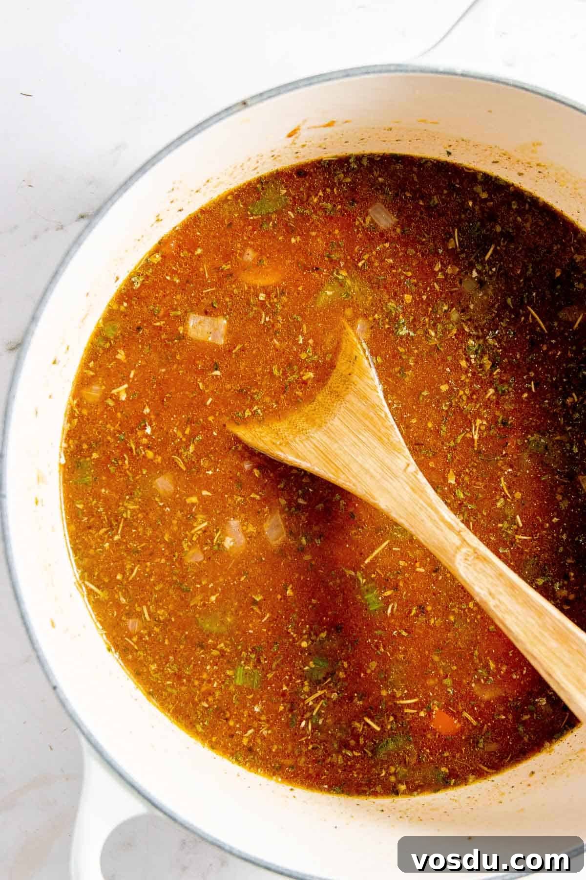 Creamy Chicken Enchilada Soup Recipe for Cozy Weeknight Dinners 6 A pot of soup with a wooden spoon in it.