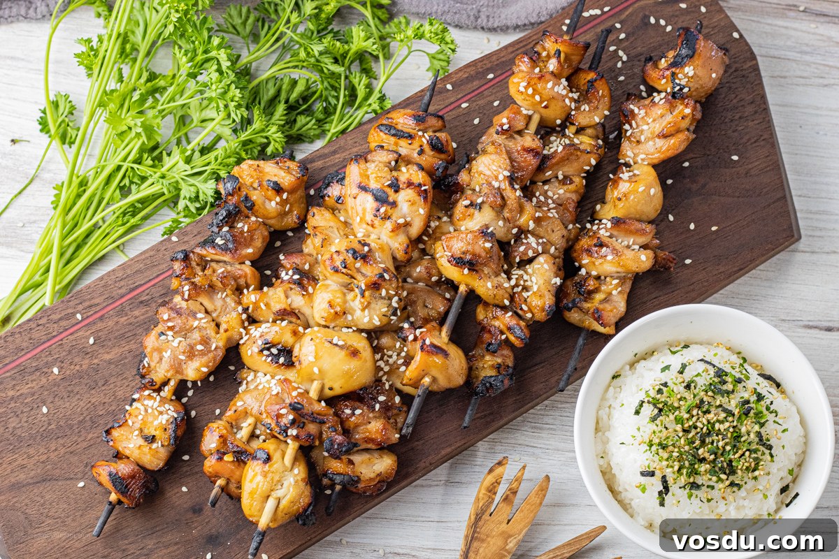 Sticky Teriyaki Chicken Skewers with Sesame and Green Onion 5 chicken teriyaki skewers on a wooden cutting board