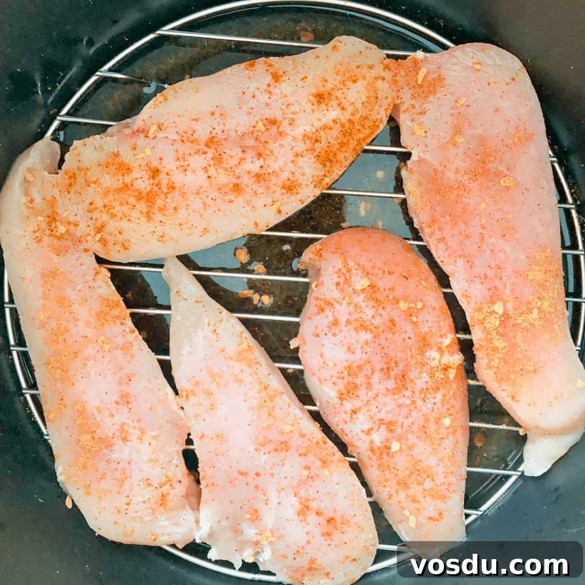 Instant Pot Frozen Chicken Breast: Juicy Chicken in 30 Minutes 5 Frozen chicken breasts sprinkled with seasoning in the Instant Pot.
