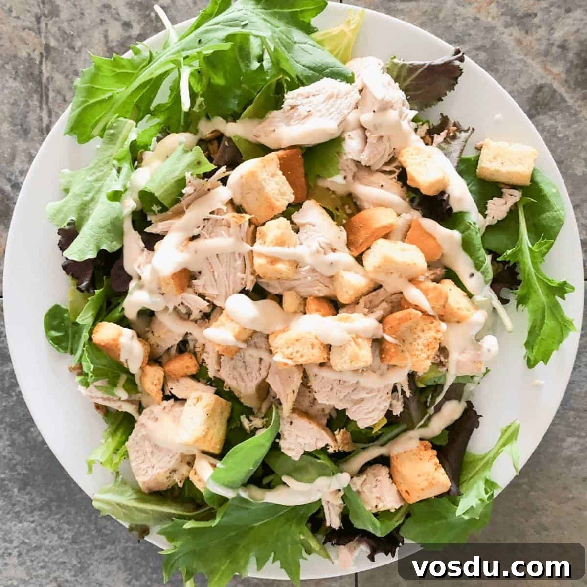 Instant Pot Frozen Chicken Breast: Juicy Chicken in 30 Minutes 7 Shredded chicken breasts on a green salad, topped with ranch dressing.