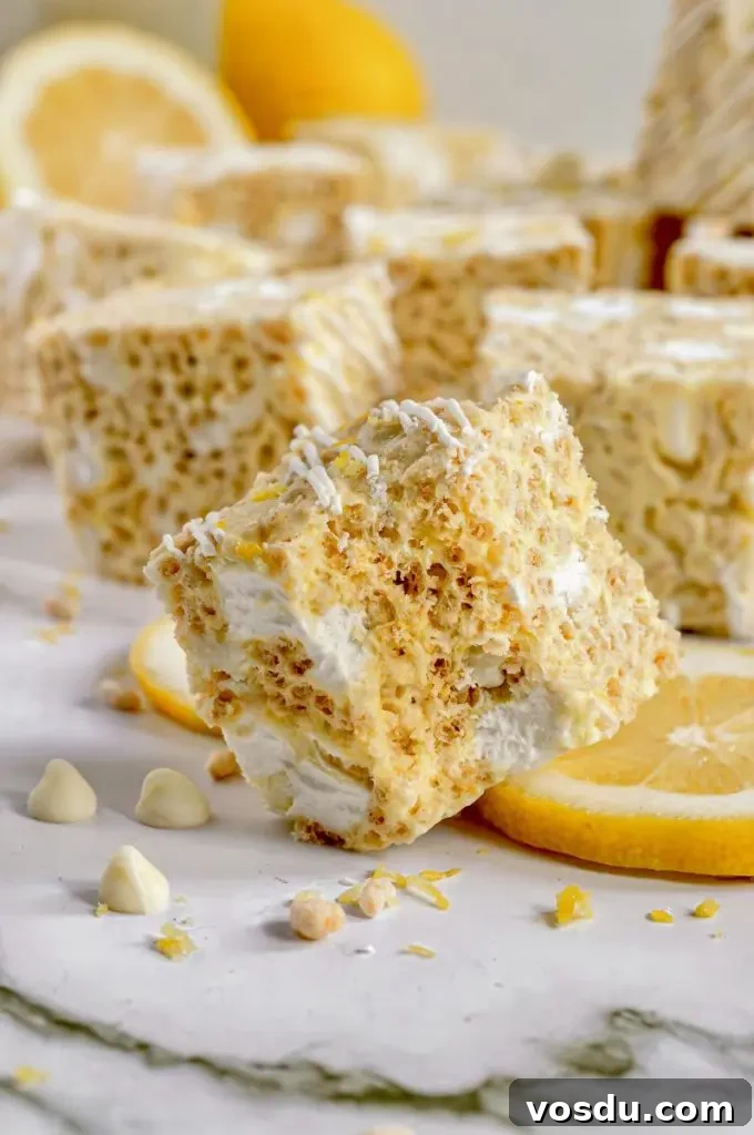 Gluten-Free Vegan No-Bake Chocolate Bars Recipe 10 Bright yellow lemon rice krispie treats with bright white marshmallows and white chocolate drizzled on top.
