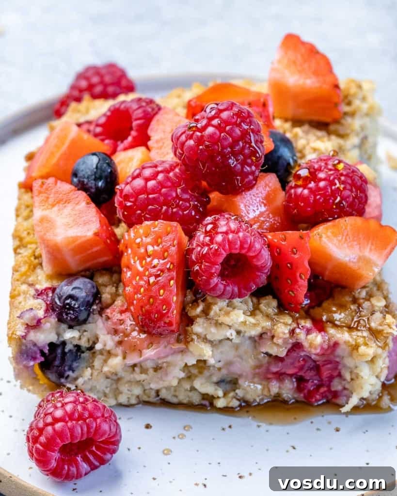 side shot of a slice of oatmeal bake with berries 