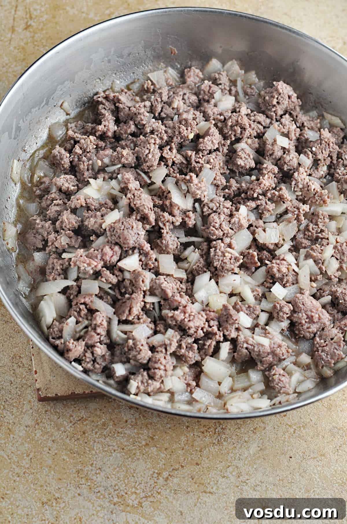 Slow Cooker Hungarian Goulash Recipe for Tender Beef 5 Cooked ground beef and chopped onions in skillet.