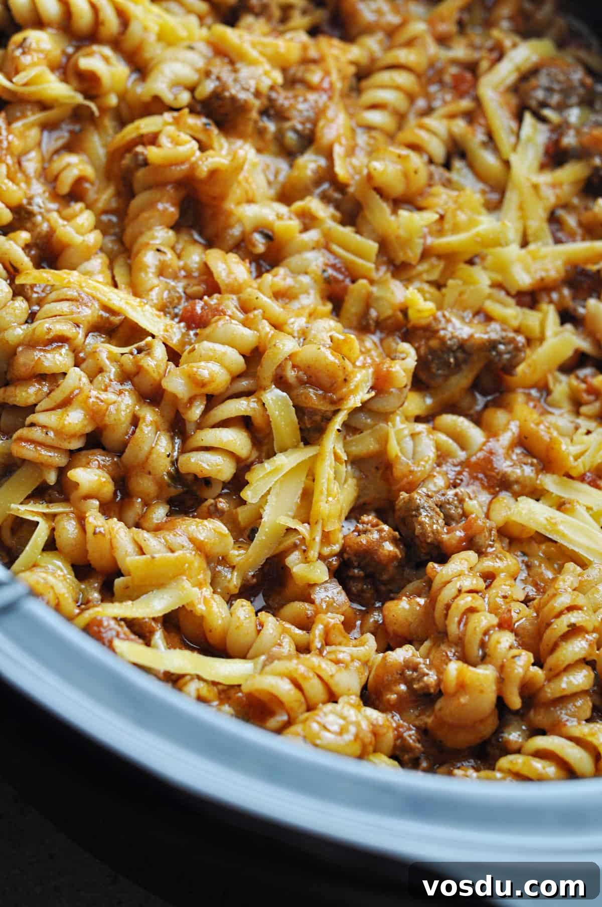 Slow Cooker Hungarian Goulash Recipe for Tender Beef 9 Rotini pasta with ground beef and cheese and spices cooking in slow cooker.