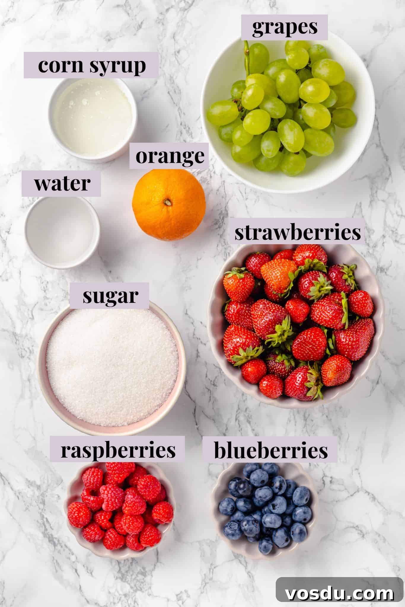 Tanghulu is one part fruit, one part candy and entirely delicious! Fruit skewers dipped in candy coating to create a sweet, crunchy shell. Overhead view of ingredients for tanghulu with labels
