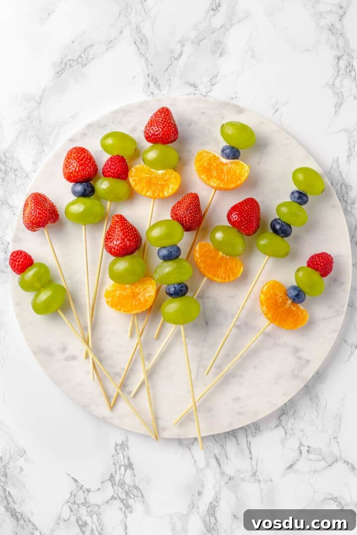 Fruit skewers on a marble slab Overhead view of fruit skewers on marble slab