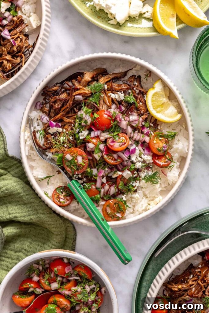 Crispy Greek beef bowl served on a styled table with green linen napkins and fresh ingredients