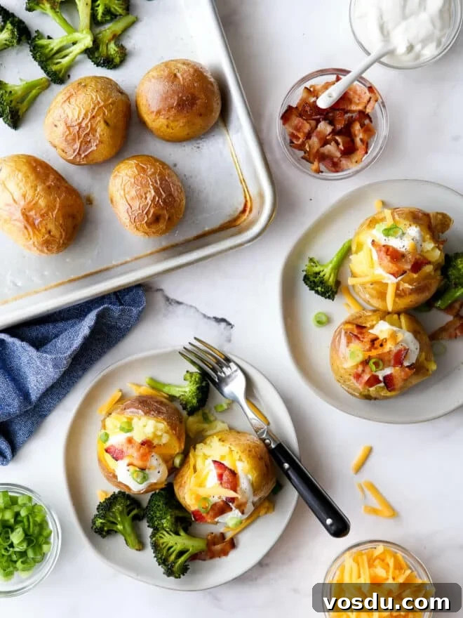 Loaded Baked Potato Sheet Pan Dinner -> Sheet Pan Loaded Baked Potato Dinner for Family Meals 2 plating baked potato servings with toppings and sheet pan in the corner