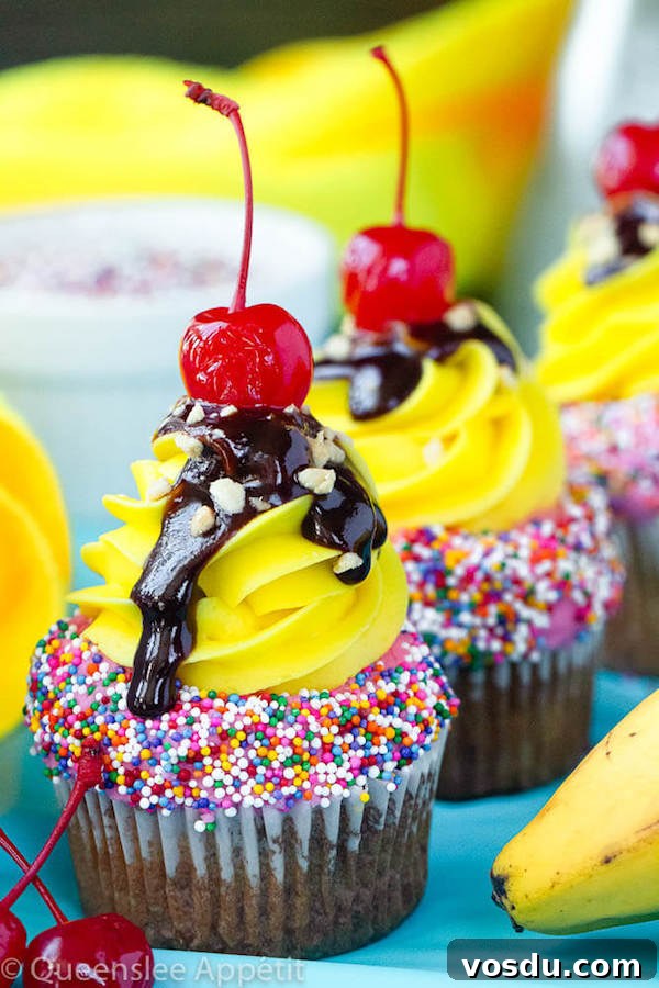 Banana Split Cupcakes Banana split cupcakes with strawberry and vanilla buttercream, sprinkles, chocolate sauce, chopped nuts and a cherry
