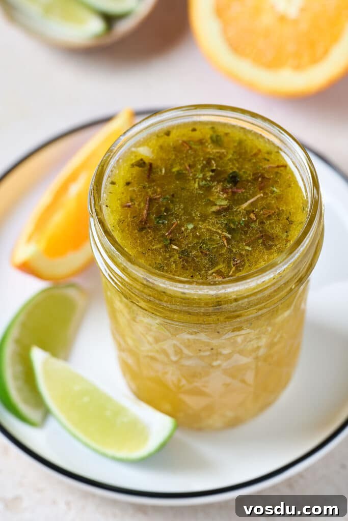 Authentic Cuban Mojo Sauce Recipe for Marinades & Dips 2 a glass jar with mojo sauce