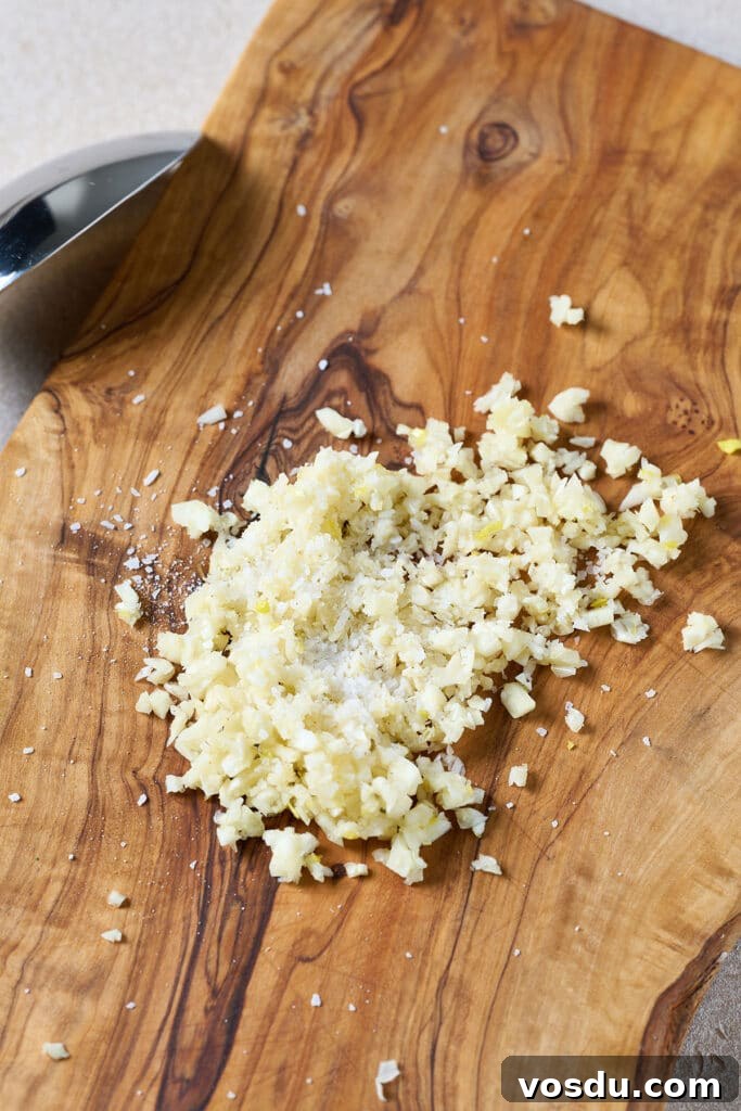 Authentic Cuban Mojo Sauce Recipe for Marinades & Dips 4 Minced garlic with salt on a cutting board