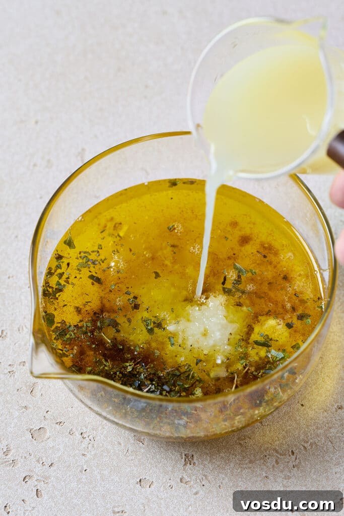 Authentic Cuban Mojo Sauce Recipe for Marinades & Dips 6 Adding lemon juice to a container with herbs, grlic and oil