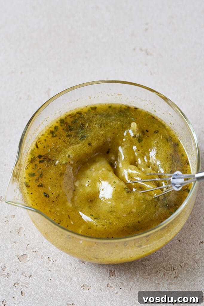 Authentic Cuban Mojo Sauce Recipe for Marinades & Dips 7 Whisking mojo sauce in a glass container