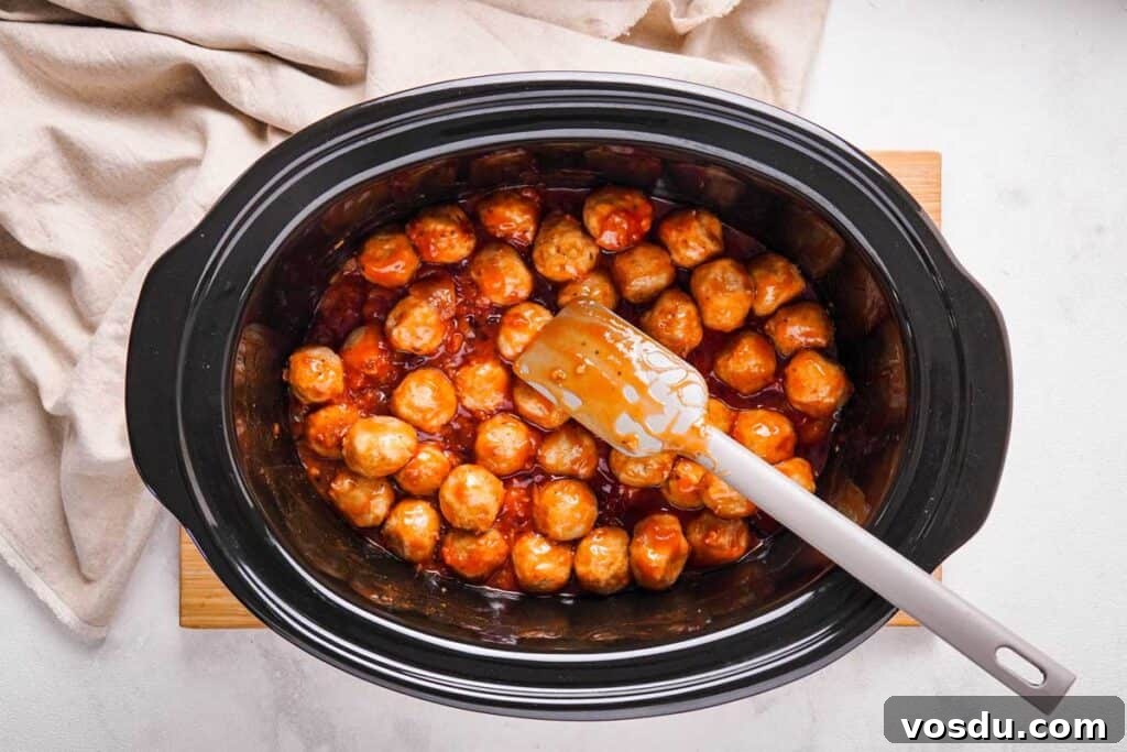 Slow-Cooker Apple Jelly Meatballs for Party Appetizers 4 apple jelly meatballs in a slow cooker from overhead