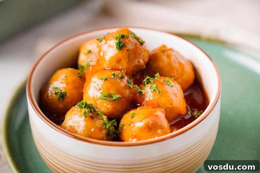 Slow-Cooker Apple Jelly Meatballs for Party Appetizers 6 meatballs served in a bowl