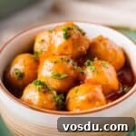 close up of apple jelly meatballs in bowl