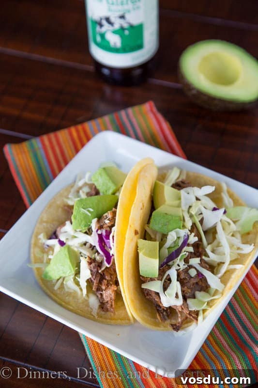 Chipotle Slow-Cooker Beef Tacos for Flavorful Weeknight Meals 4 slow cooker chipotle beef tacos on a plate