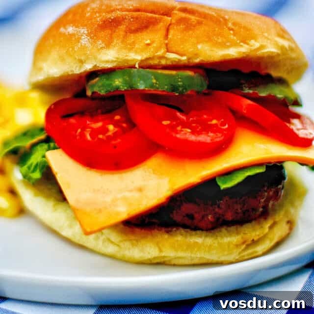 Ultimate Guide to Burgers: Build Your Own Burger Bar at Home 11 the ultimate burger with meat, cheese, tomatoes, pickles, bun on a plate