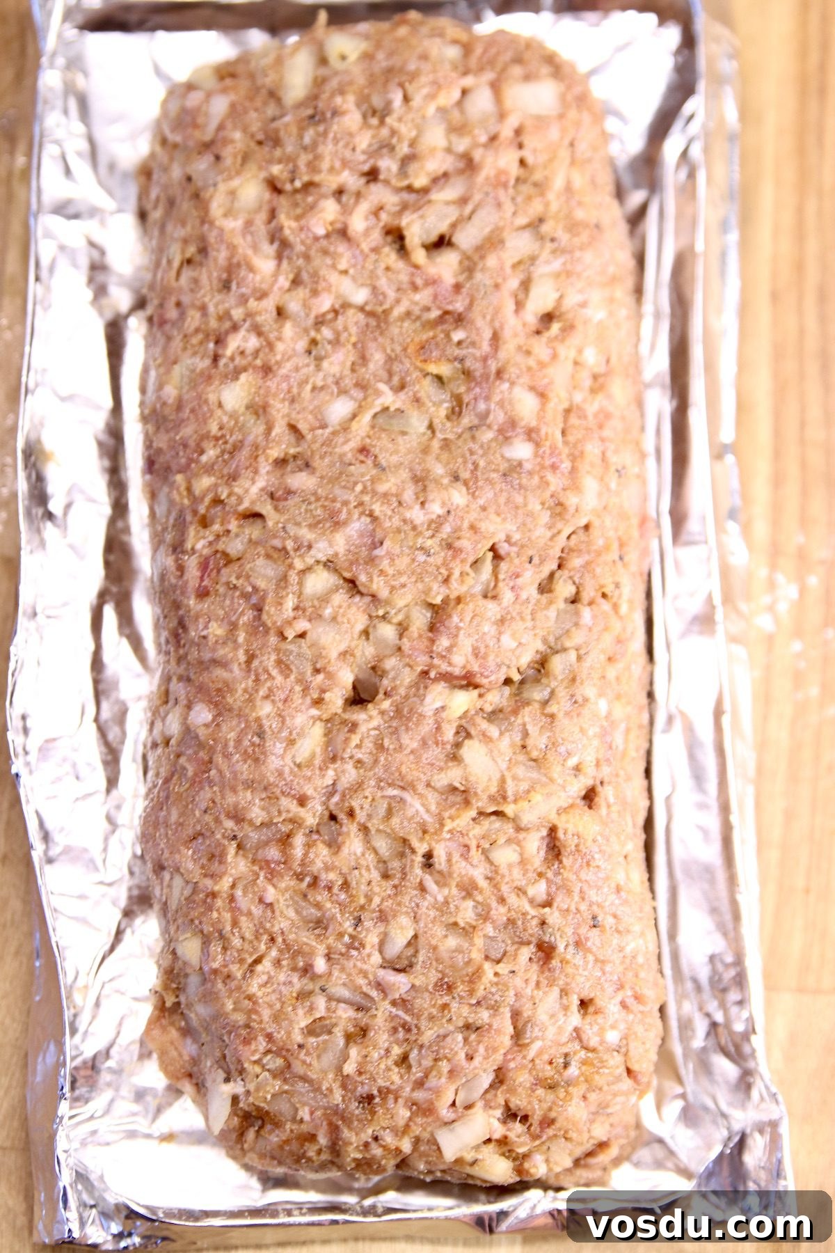Classic meatloaf mixture raw meatloaf mixture on a foil pan