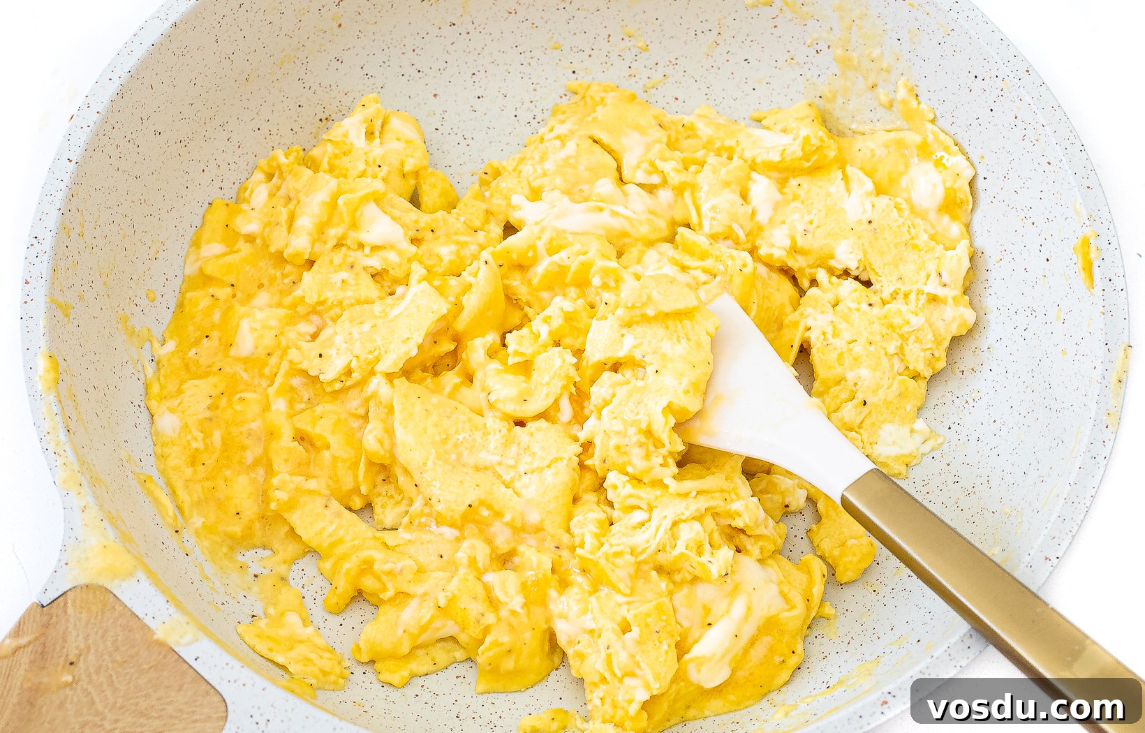 Authentic Thai Pineapple Fried Rice Recipe with Shrimp and Cashews 4 Scrambled eggs in a white skillet.