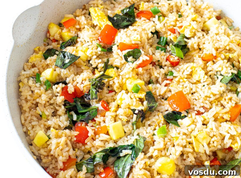 Authentic Thai Pineapple Fried Rice Recipe with Shrimp and Cashews 8 Thai Pineapple Fried Rice in a white skillet.