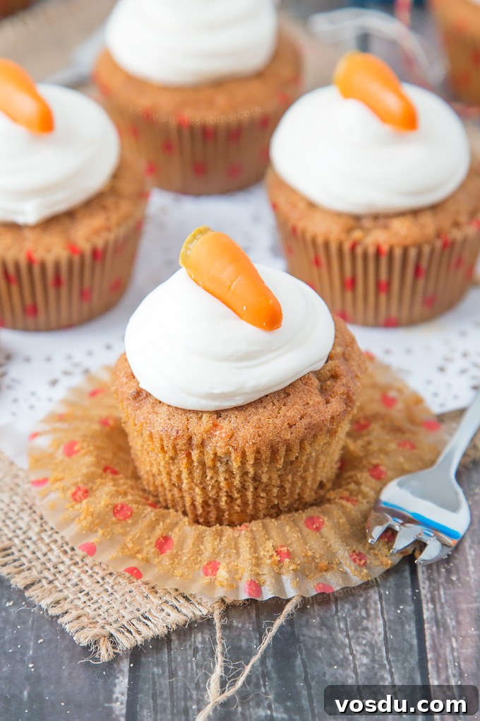 These Carrot Cupcakes are spicy, sweet, jam packed with shredded carrot and topped with a smooth, fluffy Marshmallow Frosting.