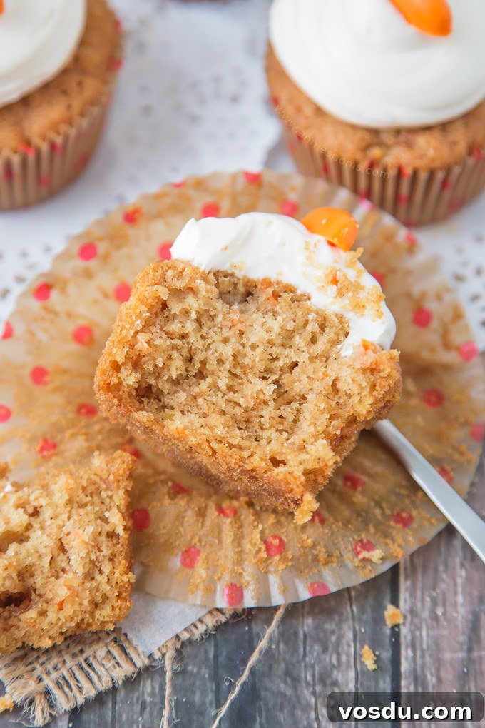 These Carrot Cupcakes are spicy, sweet, jam packed with shredded carrot and topped with a smooth, fluffy Marshmallow Frosting.