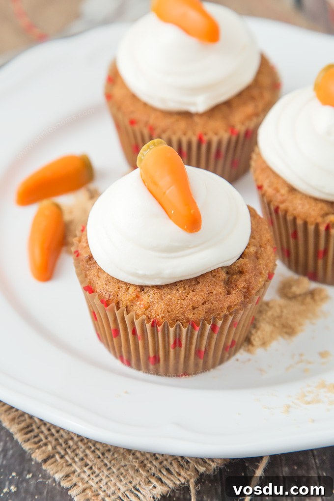 These Carrot Cupcakes are spicy, sweet, jam packed with shredded carrot and topped with a smooth, fluffy Marshmallow Frosting.