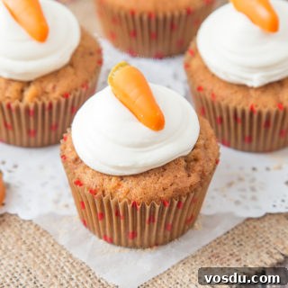 These Carrot Cupcakes are spicy, sweet, jam packed with shredded carrot and topped with a smooth, fluffy Marshmallow Frosting.