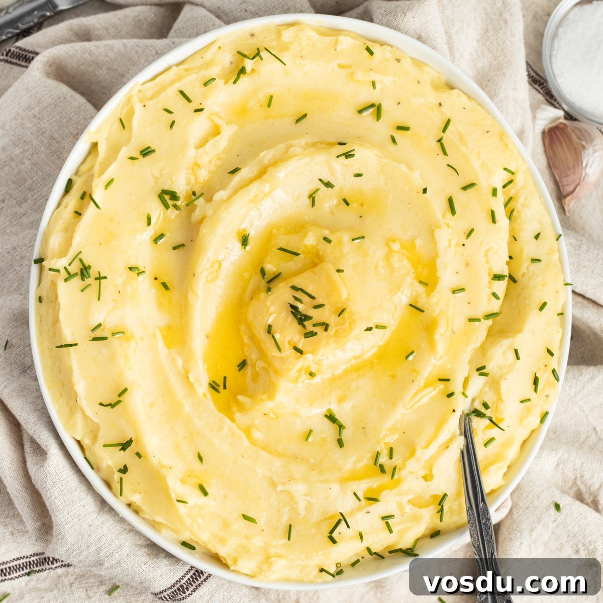 This is a square picture of a bowl with mashed potatoes with cottage cheese.